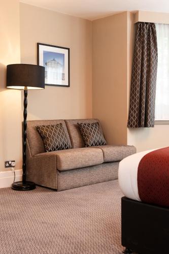 a hotel room with a couch and a bed at Miller & Carter Brighton by Innkeeper's Collection in Brighton & Hove