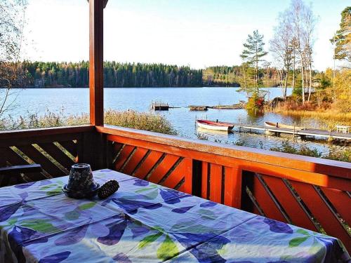 a table on a balcony with a view of a lake at 2 person holiday home in BENGTSFORS in Bengtsfors