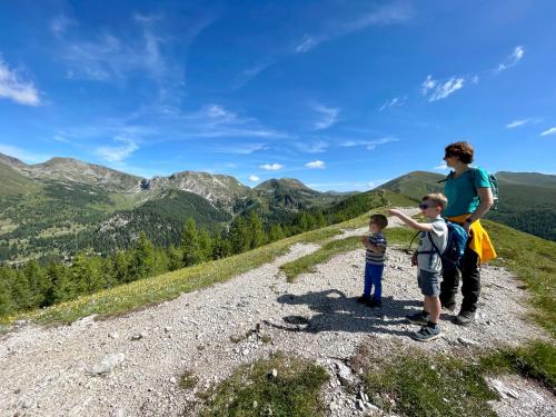 a woman and two children standing on a mountain at Sunshine @ Rosie Design Chalet in Bad Kleinkirchheim