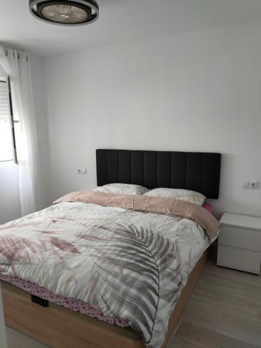 a bed with a black headboard in a bedroom at Maya in Era de Soler