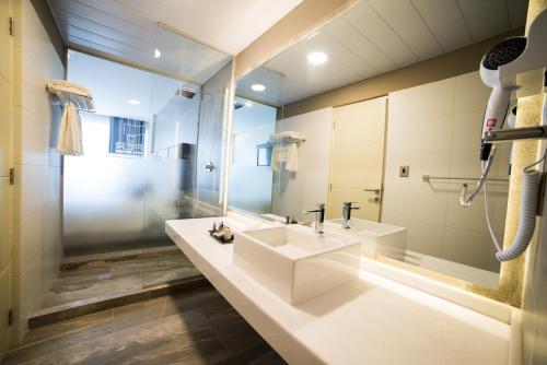 a bathroom with a sink and a mirror at Huper Hotel Boutique in Cochabamba