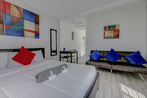 a bedroom with a white bed and a couch at Adorable private apartments in the Heart of Miami! in Miami