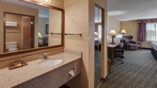a hotel bathroom with a sink and a mirror at Best Western Plus Kelly Inn and Suites in Fargo