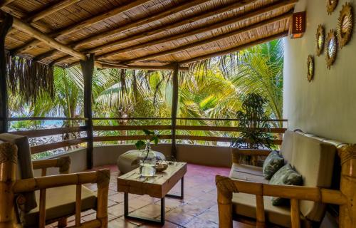 a living room with a couch and a table at Las Olas in Máncora