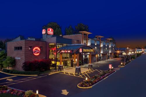 a street view of a shopping center at night at Poco Inn and Suites Hotel and Conference Center in Port Coquitlam