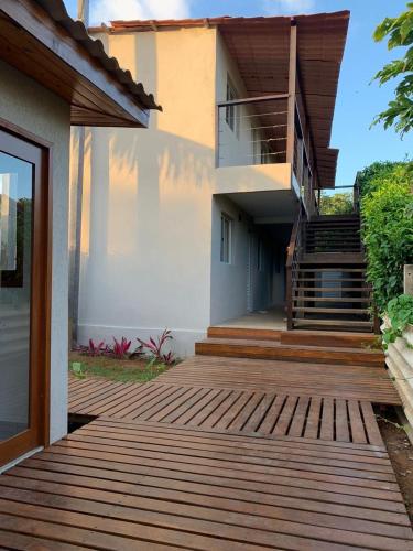 a house with a wooden walkway in front of it at Pousada Maresia in Fernando de Noronha