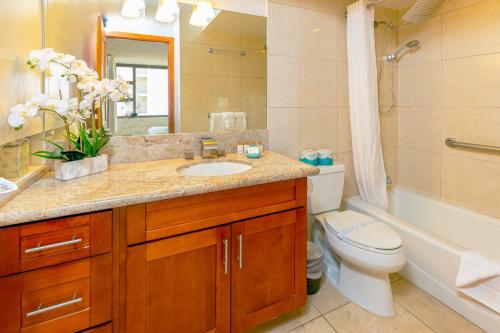 ein Badezimmer mit einem Waschbecken, einem WC und einer Badewanne in der Unterkunft Ocean View Delight, Walk to Beach with Free Parking in Honolulu