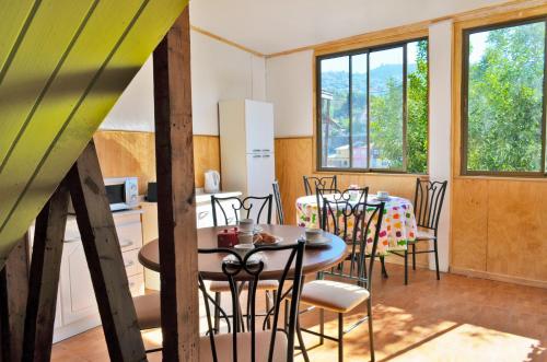 kuchnia i jadalnia ze stołem i krzesłami w obiekcie Hostal Destino Bellavista w mieście Valparaíso