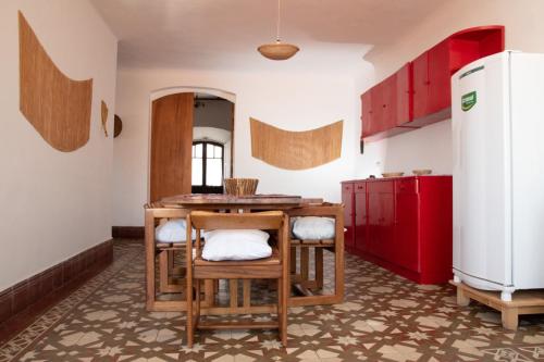 a kitchen with a table and chairs and a refrigerator at Wasi planta alta in Sucre