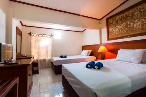 Кровать или кровати в номере Mahajaya Hotel Denpasar