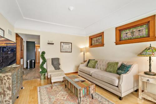a living room with a couch and a table at Milwaukee Bungalow in Milwaukee