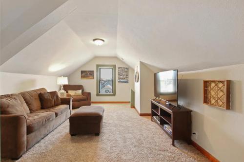 a living room with a couch and a tv at Milwaukee Bungalow in Milwaukee