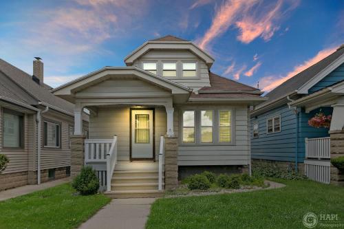 a house with a white door and a yard at Milwaukee Bungalow in Milwaukee