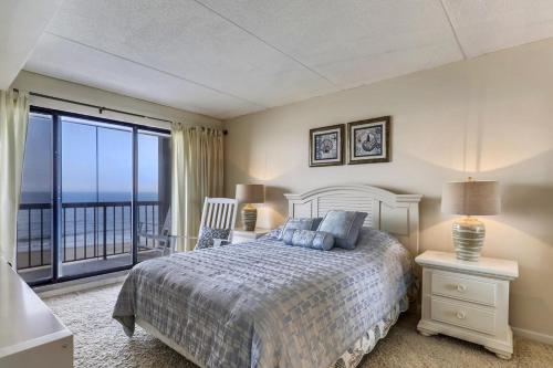 a bedroom with a bed and a view of the ocean at Rainbow Condos II in Ocean City