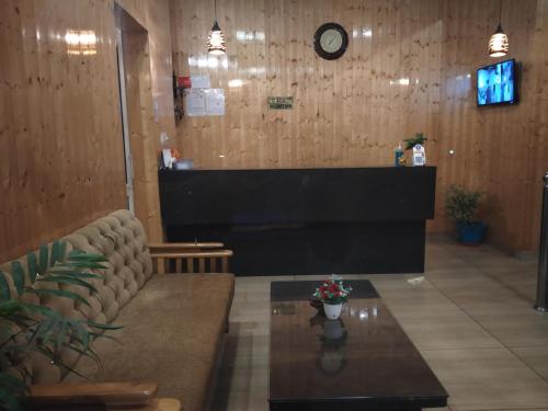 a waiting room with a couch and a table at ROYAL BREEZE HOTEL & RESTAURANT Received Most Rated Traveller Award Property For Year 2023-2024 !! in Mussoorie