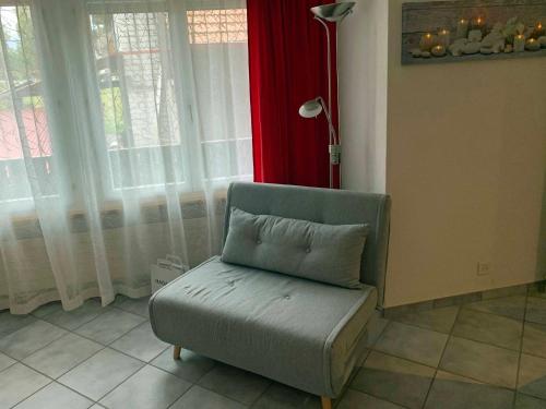 a chair with a pillow in a room with windows at Mountain Home - ein Aufenthalt mit Weitblick in Niedermuhlern