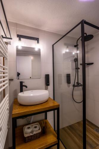 a bathroom with a white sink and a mirror at Villa Prespa in Dolno Dupeni