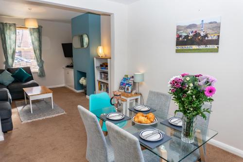 a living room with a glass table and chairs at Cheltenham-2 Bed House-Sleep 6-Parking-Garden-Wifi in Cheltenham