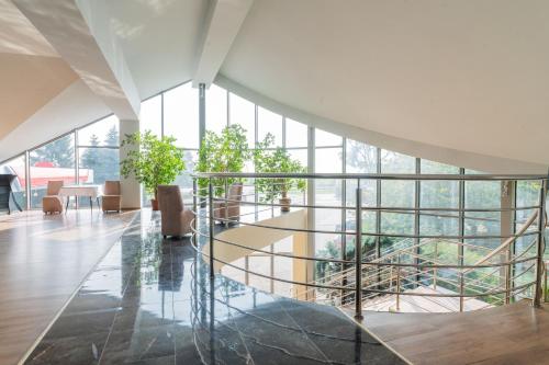 a glass staircase in a building with windows at Hotel Odejewscy in Chojnice