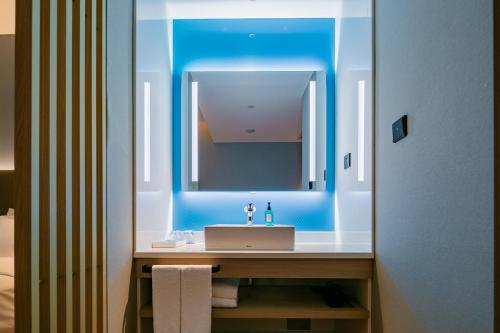 a bathroom with a sink and a mirror at Holiday Inn Express Xi'an High Tech Zone North, an IHG Hotel in Xi'an
