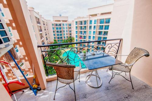 a balcony with a table and chairs on a balcony at Atlantis Residence in Jomtien Beach