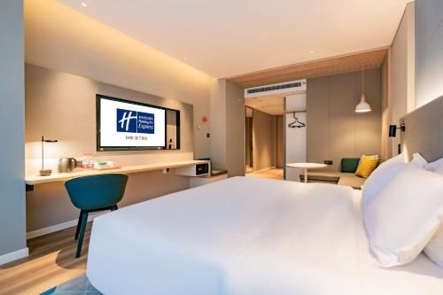 a hotel room with a bed and a television at Holiday Inn Express Xi'an High Tech Zone North by IHG in Xi'an