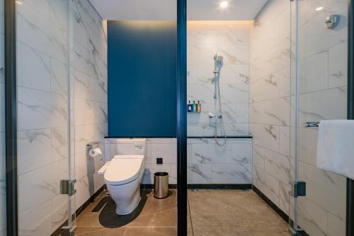 a bathroom with a toilet and a shower at Holiday Inn Express Xi'an High Tech Zone North by IHG in Xi'an