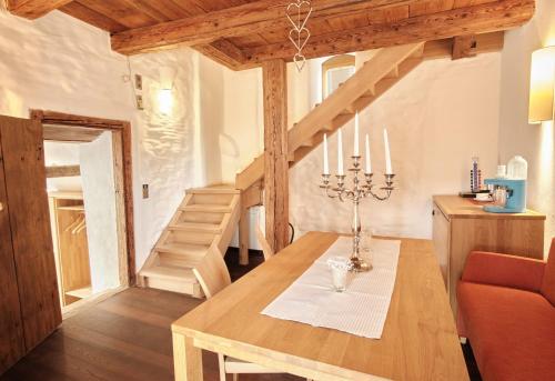 a dining room with a table and some stairs at Turmhotel zum Erasmus in Kelheim