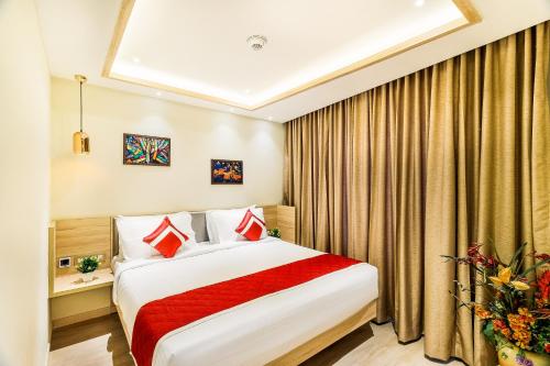 a hotel room with a large bed with red blanket at Hotel Jagadish International-Sankey Road in Bengaluru