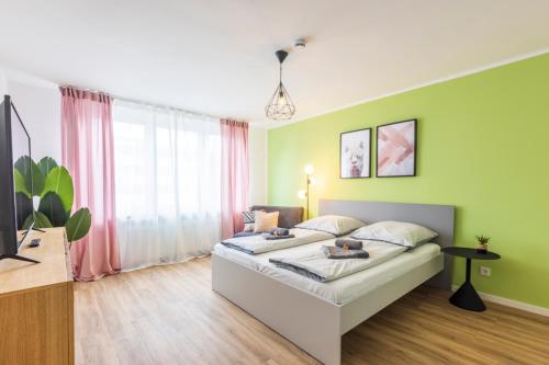 a bedroom with a bed and a large window at Glück Auf Appartements Kaiserstraße Mülheim in Mülheim an der Ruhr