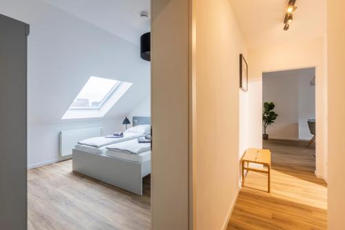 a bedroom with a bed and a skylight at Glück Auf Appartements Kaiserstraße Mülheim in Mülheim an der Ruhr