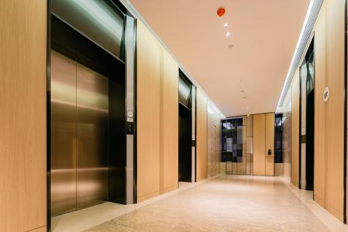 a hallway with elevator doors in a building at Holiday Inn Express Xi'an High Tech Zone North by IHG in Xi'an