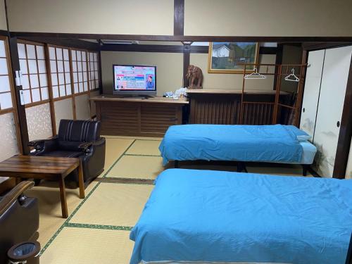 a room with two beds and a desk with a television at Cafe Restaurant Umi no Yado Awaji Island - Vacation STAY 61253v in Awaji