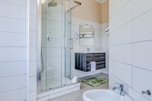 a white bathroom with a shower and a sink at Asso Residence Centro in Terni