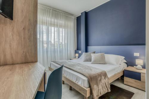 a bedroom with a bed and a blue wall at Asso Residence Centro in Terni