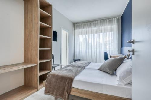 a bedroom with a large bed and a window at Asso Residence Centro in Terni