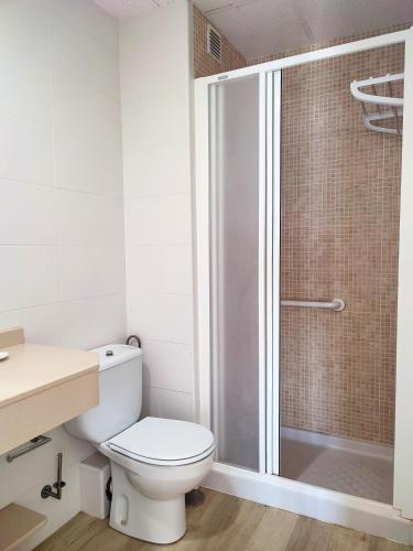 a bathroom with a toilet and a shower at Flats Friends Atlantida in Benidorm