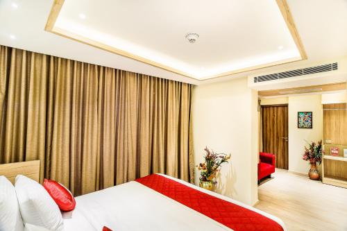 a hotel room with a bed and a couch at Hotel Jagadish International-Sankey Road in Bengaluru
