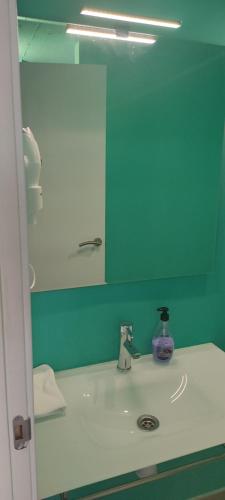 a bathroom with a sink and a mirror at valencialoft in Valencia