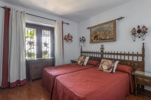 a bedroom with a red bed and a window at Villa Paraíso Azul in Salobreña