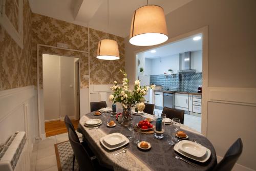 a kitchen and dining room with a table and chairs at Heart of Pamplona Palace in Pamplona