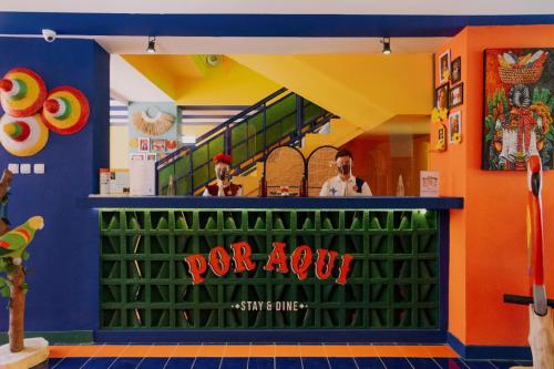 a restaurant with a for now sign on a garage door at Por Aqui Stay & Dine in Yogyakarta