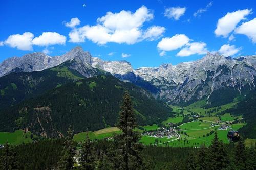 a view of a mountain with a town in a valley at Alpen Apartment Werfenweng - Ruhe - Pool in Werfenweng