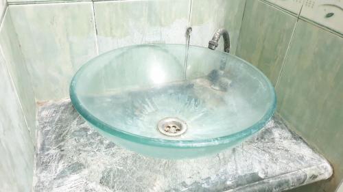 a blue sink with a faucet in a bathroom at Castle Residence Syariah RedPartner in Siwalapkerto