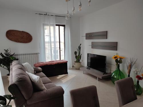 a living room with a couch and a television at Serena GuestHouse in Monopoli