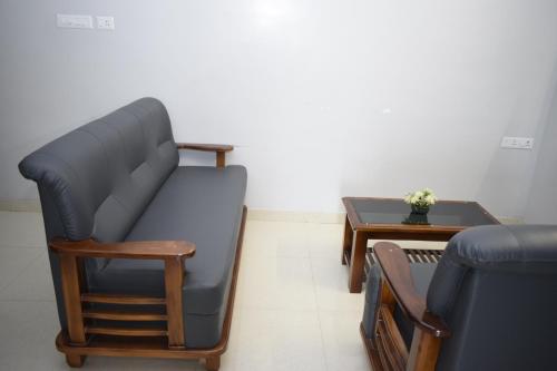 a waiting room with a couch and a table at Viswa Residency by Azalea in Madurai