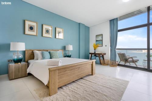 a bedroom with a large bed with blue walls at bnbmehomes - Rare Find on the Palm Jumeirah - 100 in Dubai