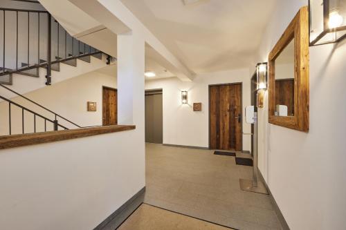 a hallway of a house with stairs and a hallway at City Suites Murnau in Murnau am Staffelsee