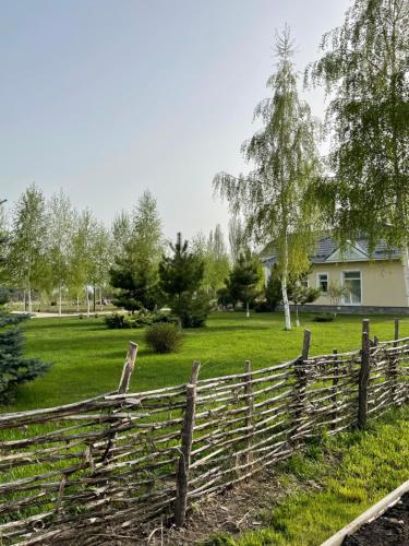 a wooden fence in front of a house at Усадьба Кутурга in Kuturga