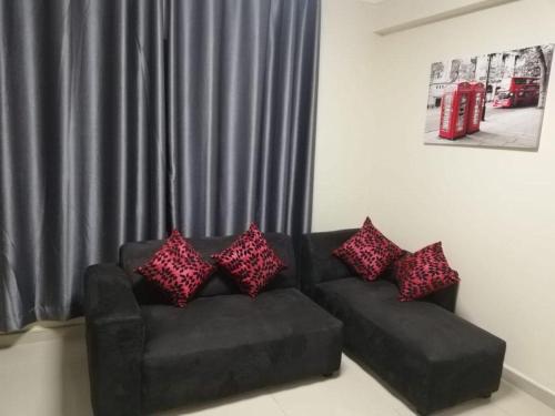 a living room with a couch with pillows on it at Afsaal flats in Amanzimtoti